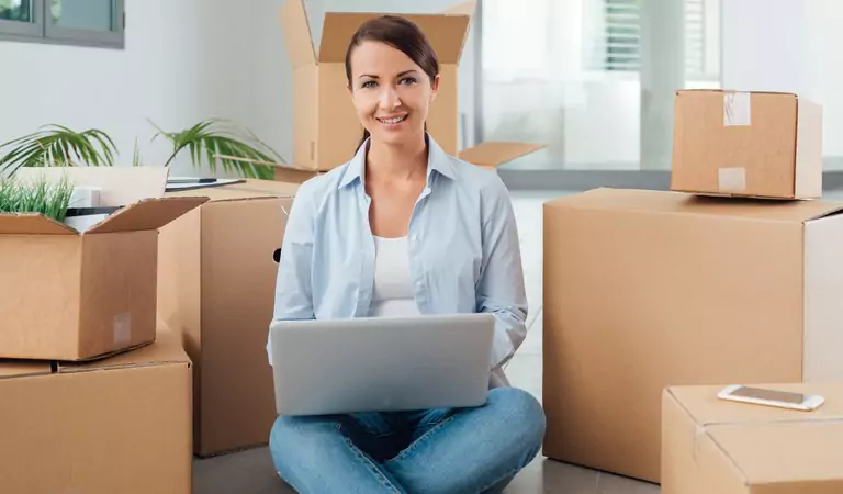 young woman with a laptop sitting on the floor