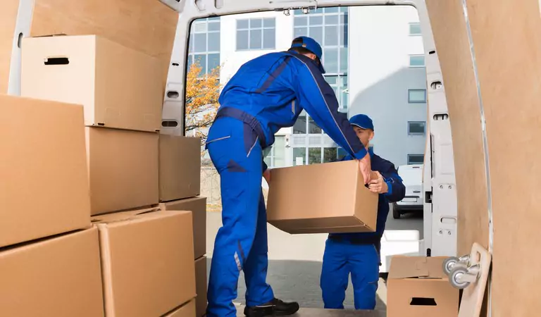 professionals unloading a truck full of boxes