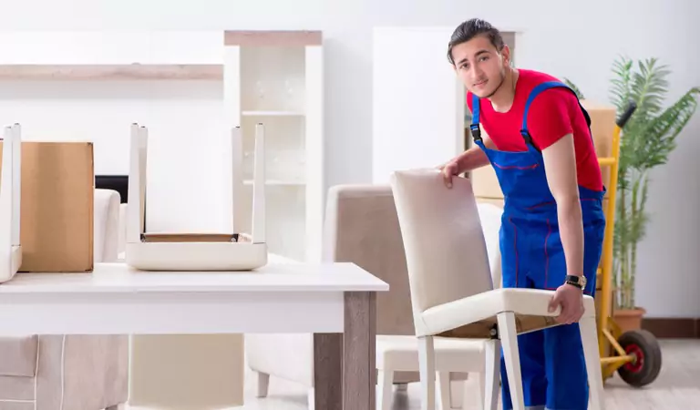 young man lifting a chair