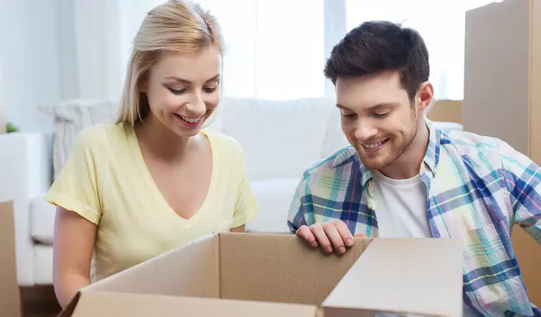 couple packing up a cardboard box
