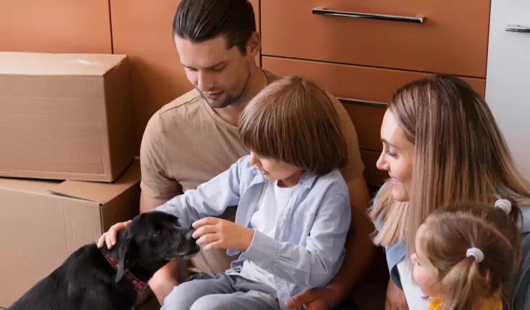 family inside of a new house with their dog