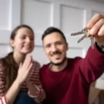 couple inside of a new house looking happy