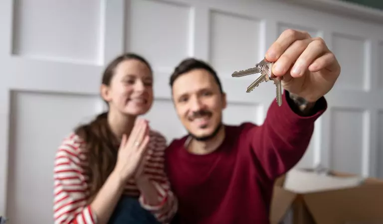 couple inside of a new house looking happy