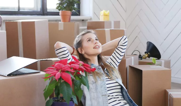 woman sitting inside of a new house looking relaxed