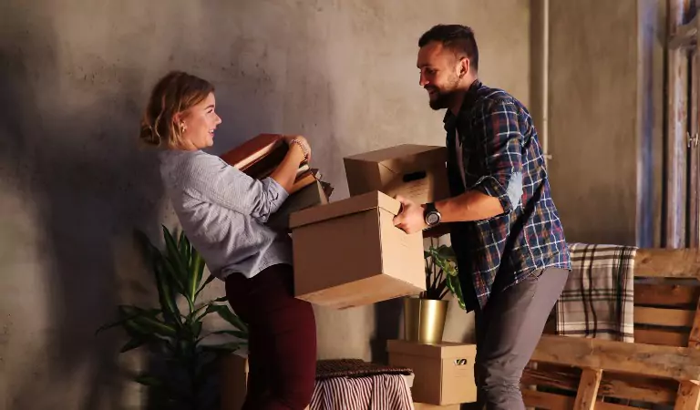 young couple during a house moving process with some cardboard boxes