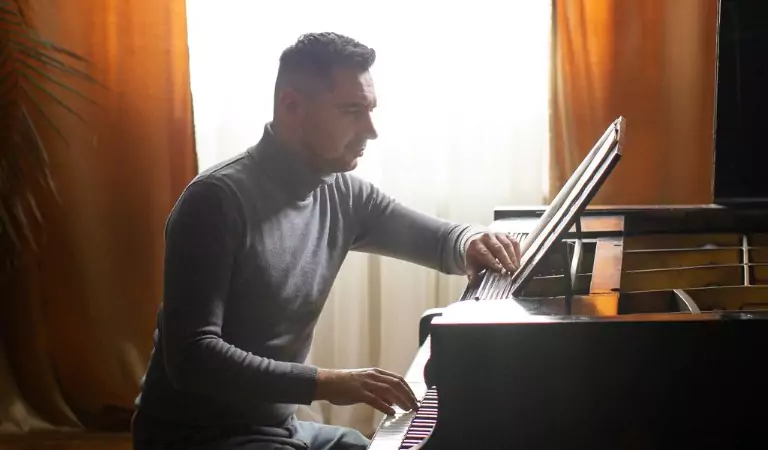 young man playing a piano