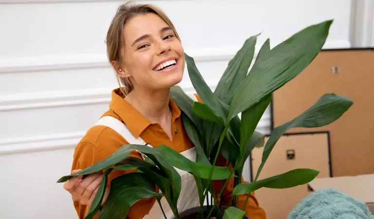 woman with a plant during a household move